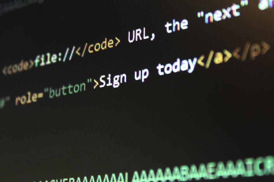 Close-up image of computer code displayed on a screen, showing lines of HTML or web development language with text such as 
